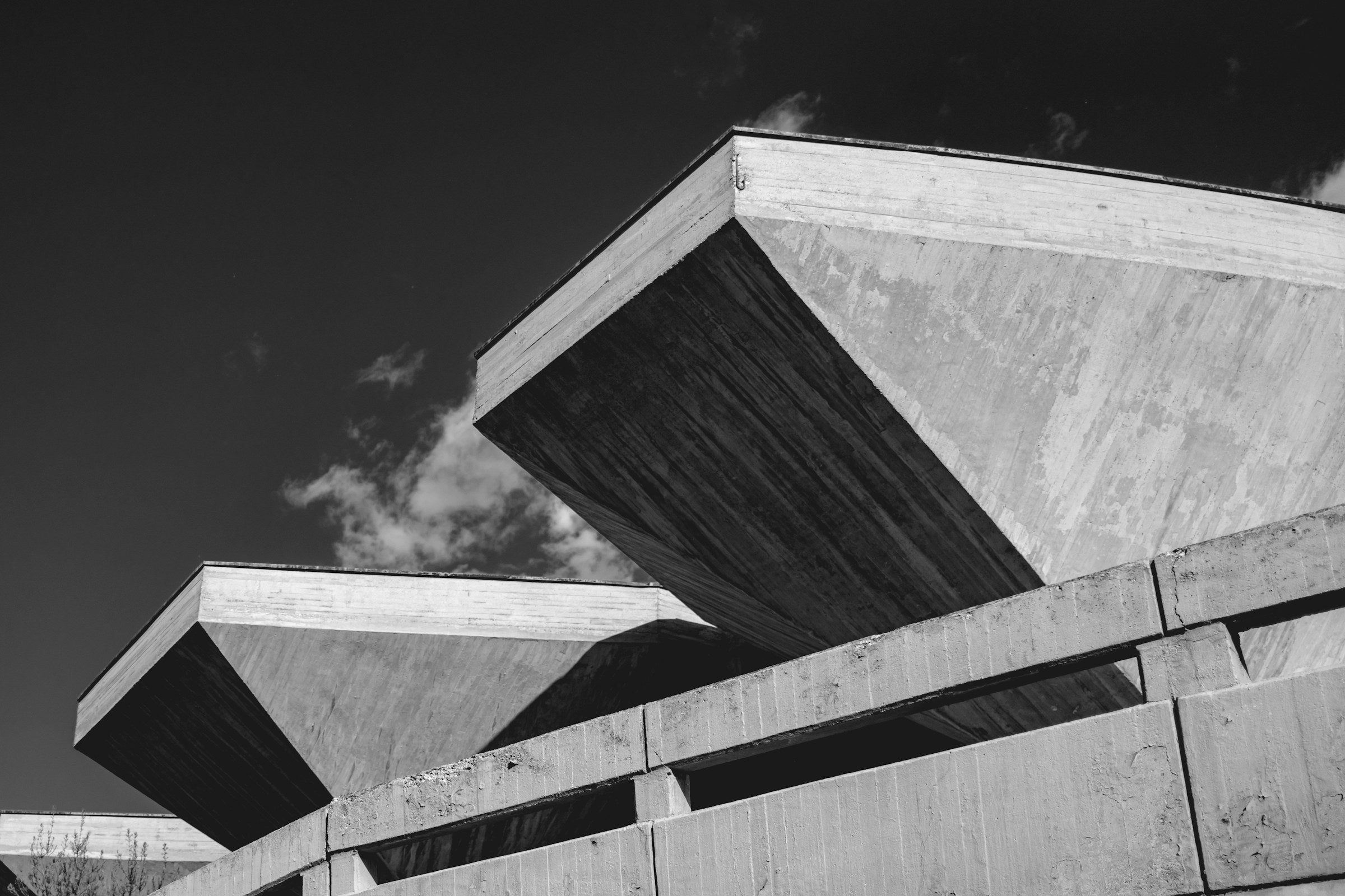Geometric concrete structure against a dark sky